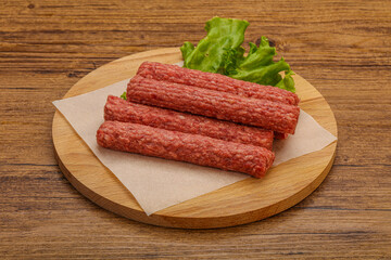 Raw beef sausages with spices