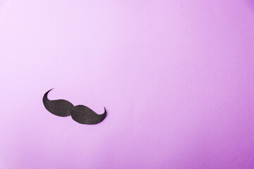 Black mustache paper, studio shot isolated on purple background, Prostate cancer awareness month,...