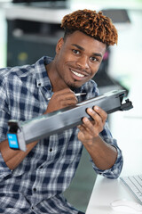 man holding pen and an industrial printer cartridge