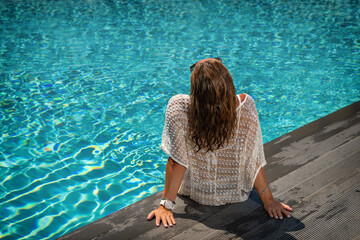 woman in luxury spa resort near the swimming pool.