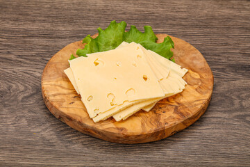 Sliced yellow cheese over board