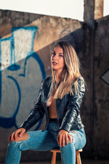 Fototapeta na wymiar Model with leather jacket and blue jeans