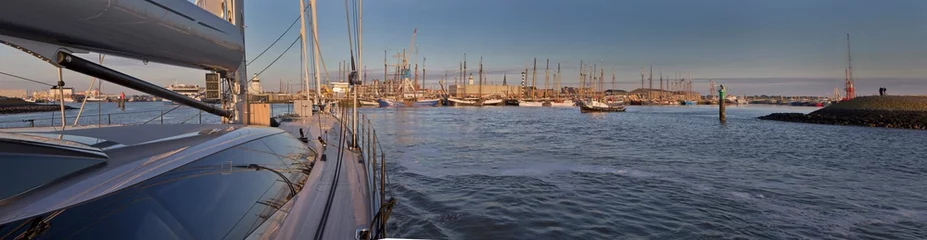 Fotobehang Entering the Port of Harlingen Friesland. Harbour. Sailing at Nortsea. Waddenzee.. Noordzee. Super sailing yacht. Netherlands. Panorama. Evening. © A