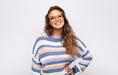  smiling happily with a hand on hip and confident, positive, proud and friendly attitude