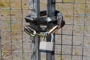 Close Up of Padlock & Chain on Old Metal Gates