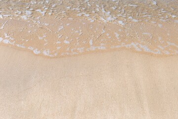 Empty clean sand beach and clear sea water wave, nature and environmental concept background, outdoor day light
