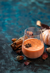 Spicy cocktail, pumpkin smoothie with cinnamon, anise. Traditional autumn food.