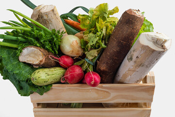 Wooden box with fresh vegetables and organic greens on white background. Bio organic food. Detox...