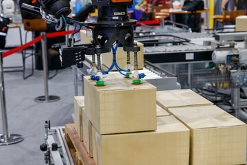 View of vacuum gripper on robot lifting the box.