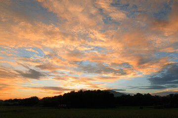 Fototapeta na wymiar The sky with orange clouds after twilight of sunset