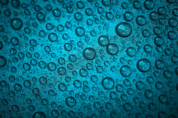 Turquoise water drops on a shiny metal background