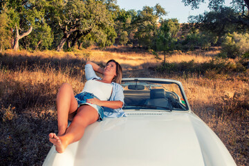 Woman with white convertible vintage car