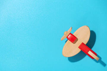 Wood airplane on blue background, top view