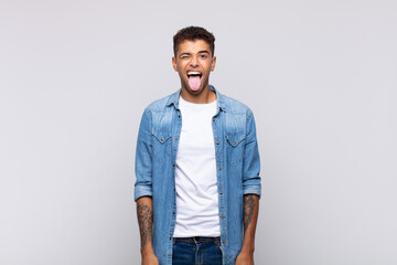  with cheerful, carefree, rebellious attitude, joking and sticking tongue out, having fun