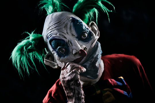 disturbing evil clown wearing a face mask