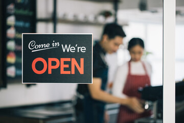 A business sign that says 'Come in We're Open' on Cafe and coffee shop or Restaurant window....