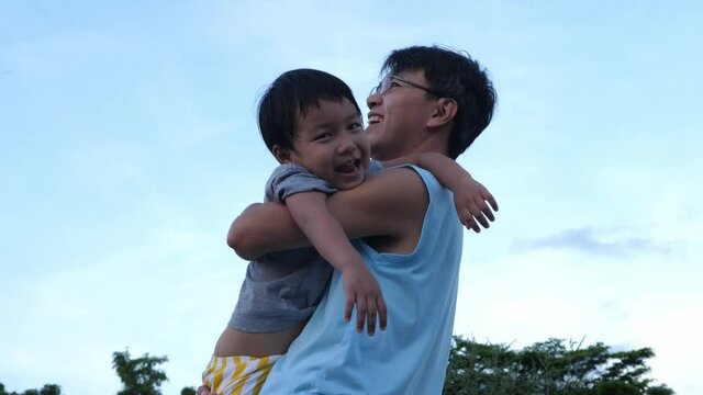 4K Asian Child Boy And Dad In Happy Moment Shot, Smiling And Laughing With Happy Cute Face Outdoor. Son In Hug Of Father. Father's Day And Relationship Concept. Real Person In Authentic Scene.