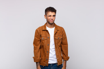  looking happy and friendly, smiling and winking an eye at you with a positive attitude