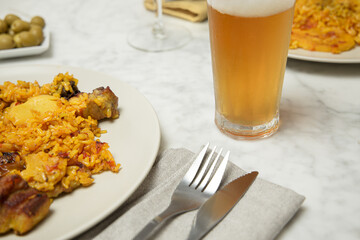 Two paella plates on a marble table ready to be eaten. Valencia, Spain