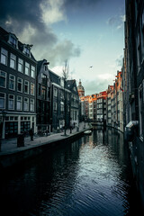 Fototapeta premium View on Amsterdam narrow street from the canal