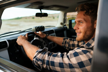 Handsome young man on a front seat of car