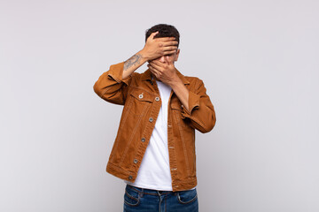  covering face with both hands saying no to the camera! refusing pictures or forbidding photos