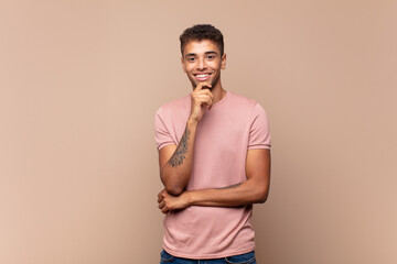  looking happy and smiling with hand on chin, wondering or asking a question, comparing options