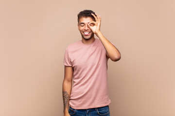  smiling happily with funny face, joking and looking through peephole, spying on secrets