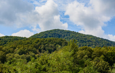 Beautiful mountain range in summer against a blue sky with clouds. blurry focus