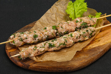 Raw minced pork skewer kebab for grill