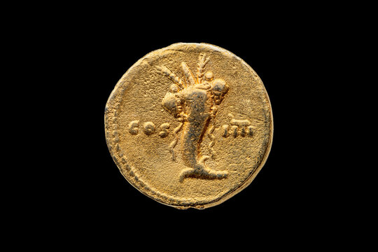 Roman gold aureus replica coin reverse of Roman Emperor Domitian AD 81-96  showing cornucopia (horn of plenty) cut out and isolated on a black background stock photo Image