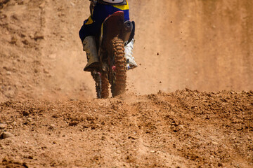 motocross show  racer accelerating in dirt track