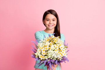 Obraz na płótnie Canvas Congratulations. Photo of cute lovely little hispanic courier lady long hairstyle hands hold bouquet give you present smile wear turquoise sweatshirt isolated pink color background