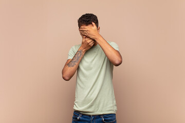  covering face with both hands saying no to the camera! refusing pictures or forbidding photos