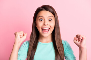 Photo of funny amazed cute lovely small latin lady long hairdo surprised raise arms fists open mouth wear casual stylish trendy turquoise teal sweatshirt isolated pink color background