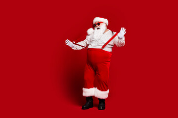Full length body size view of his he attractive cheerful fat white-haired Santa having fun pulling...