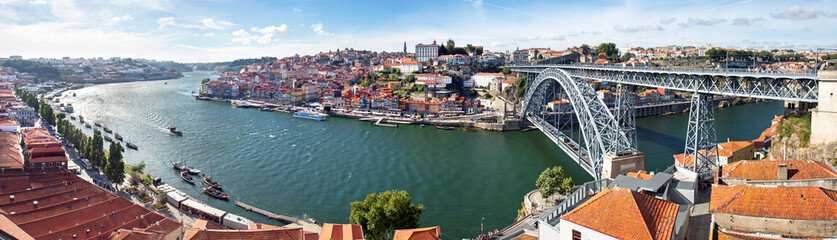 Naklejka na ściany i meble High view on the Dom Luis I bridge from Vila Nova da Gaia, looking at the old town of Porto and the Douro river.