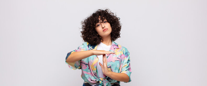  looking serious, stern, angry and displeased, making time out sign