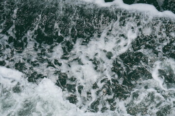 Seafoam or spume on seawater stock photo