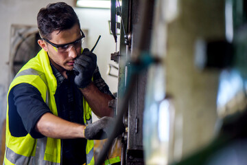 Caucasian engineer mechanic man checking for maintenance pressing metal machine at factory, worker at industrial working concept