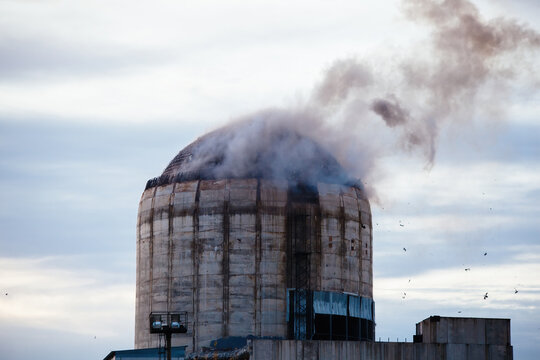 Demolition of old industrial building by exploding dynamite