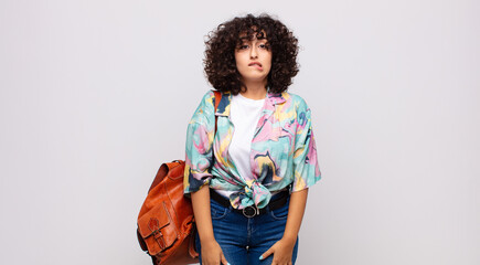  looking puzzled and confused, biting lip with a nervous gesture, not knowing the answer to the...