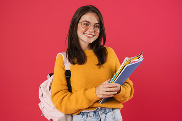 Image of happy beautiful student girl posing with exercise books