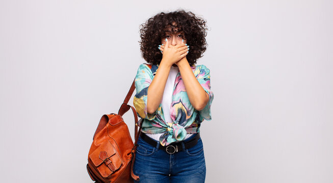  covering mouth with hands with a shocked, surprised expression, keeping a secret or saying oops