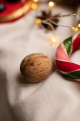 Walnut close-up lies on a light background next to a bright candy