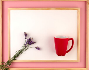 On a pink background in a wooden frame is a bouquet of lavender.Space for text.Pink and lavender.Interior for the house.