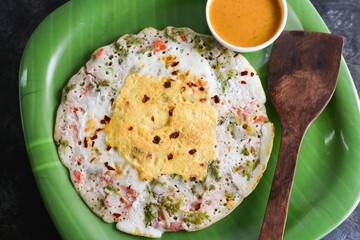 Omelette, omelet  boiled egg with Onions, green chillie, coriander, curry leaves, tomato in frying pan in Kerala, India. IndiaStreet food bred omlet. Ready to eat masala egg half boiled omeletts