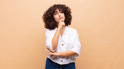  looking serious, confused, uncertain and thoughtful, doubting among options or choices