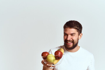 man with fresh fruit in a glass cup gesturing with hands vitamins health energy model bushy beard mustache