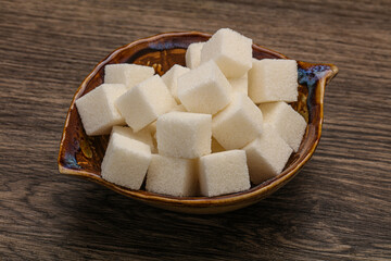 Refined white sugar cubs in the bowl